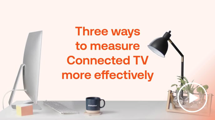 Desk with computer, lamp, and plants beside ‘Measure Connected TV effectively’ text by The Trade Desk, showing CTV analytics.